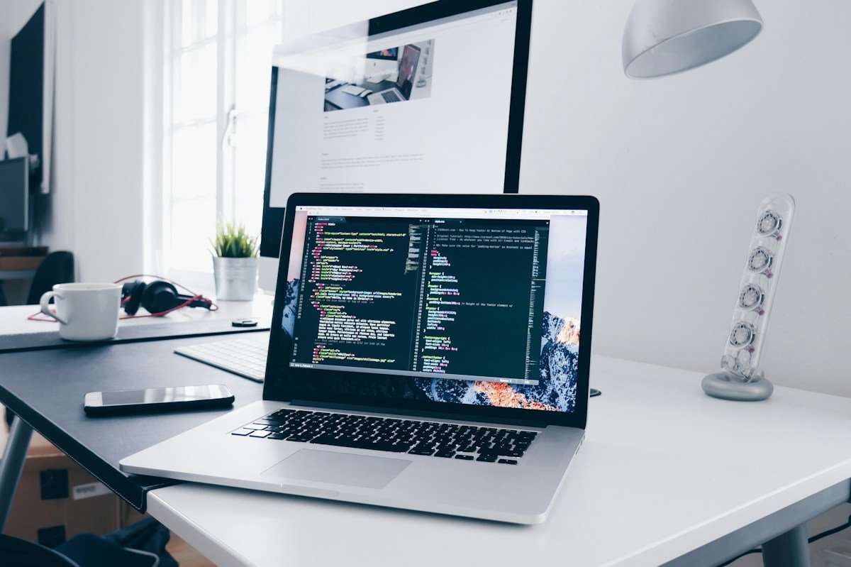 Software development workspace with laptop screens